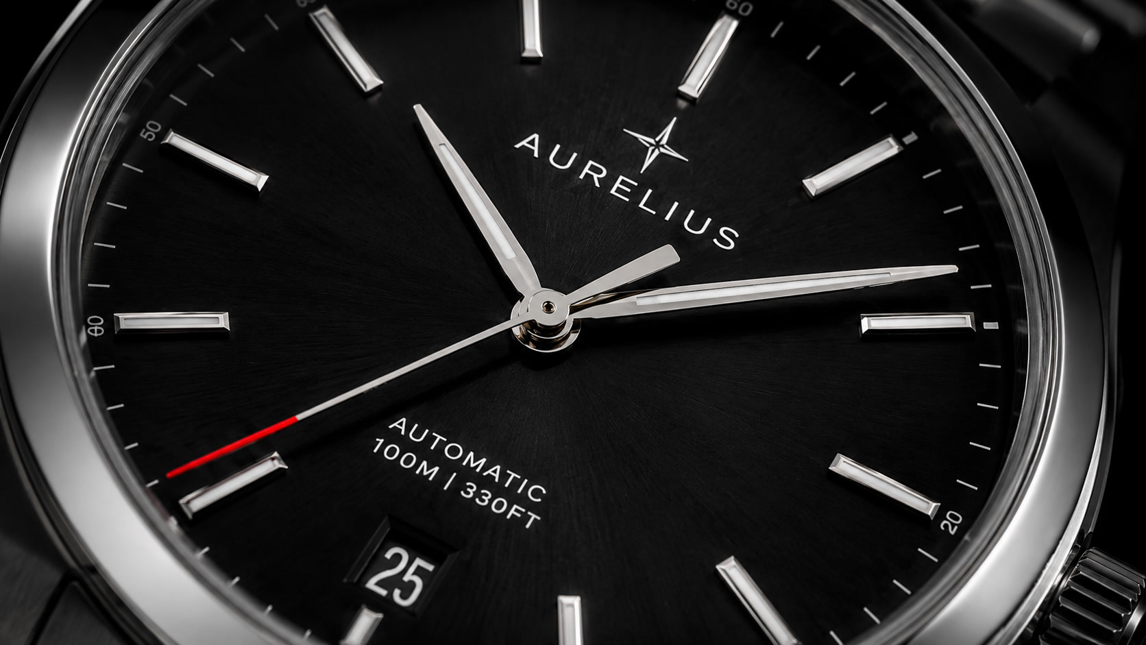 Extreme macro of the Aurelius watch dial showing applied steel indices, brushed sunburst finish and the red-tipped seconds hand